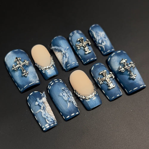 a press-on nail set hand-crafted Blue jean nail art designs with crosses, distressed look, rhinestones, matte design.